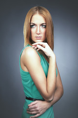 Pretty redhead girl posing in studio