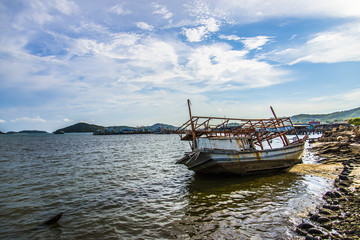 Fototapeta premium The sinked boat with fisherman village