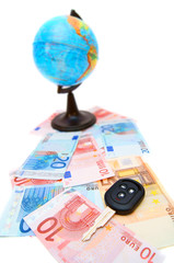 Key from the car and globe for euro banknotes.