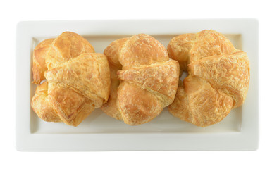 Fresh and tasty croissant on white plate