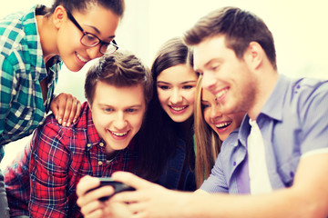 Fototapeta premium students looking at smartphone at school