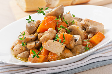 Stew chicken with vegetables and mushrooms in a cream sauce