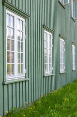 White wooden windows and green walls in Norway