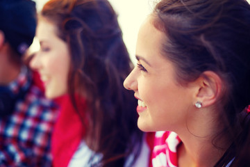 smiling teenage girl outdoors with friends