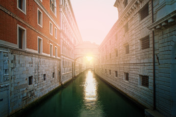 Fototapeta premium Ancient buildings and boats in the channel in Venice