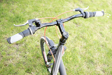 Black mountain bike on a green grass