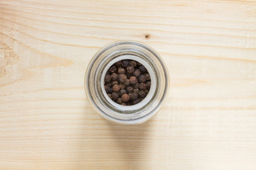 black pepper (Piper nigrum) on the wooden table - top view