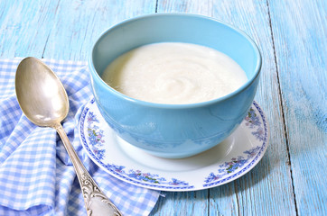 Semolina porridge on the wooden table.