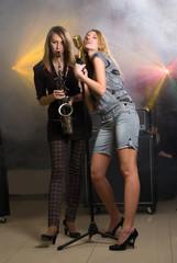 Fototapeta na wymiar Two beautiful musical women on stage
