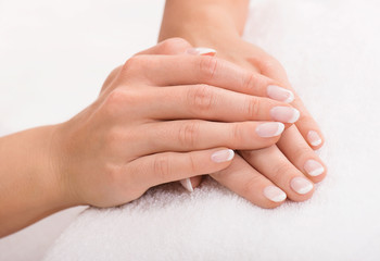 Hands on a towel with manicure