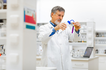 Senior male researcher carrying out scientific research in a lab