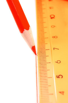 Pencil and ruler on a white background.