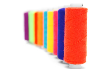 Multi-coloured threads. On a white background.