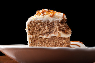 Maple Walnut Cinnamon Cake with vanilla ice cream on black background