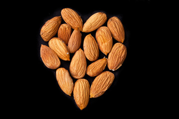 Almonds in the shape of a heart isolated on black