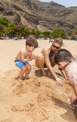 Happy family playing on the beach