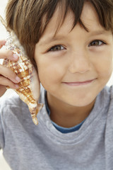 Young boy with seashell