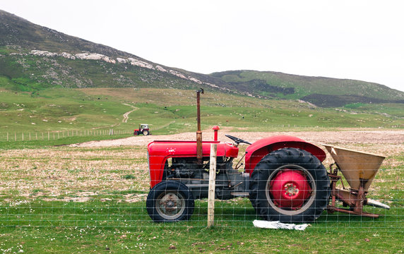 Vintage red tractor in a field in UK