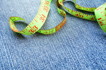 Measuring tape on a fabric (jeans).