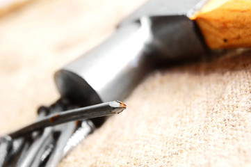 Hammer and nails on fabric.