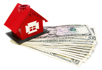 The toy house and money. On a white background.