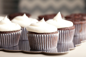 Chocolate gourmet cupcakes with sprinkles and buttercream frosting - side view