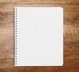 Notebook on wooden background.