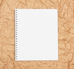 Notebook on rumpled paper.