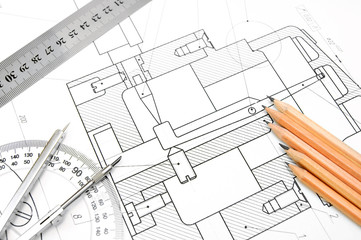 Pencils, compasses, rulers on the drawing.