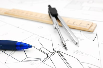 Compasses, pencil and ruler on the drawing .
