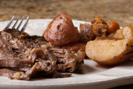 Macro Shot Of Organic Grass Fed Beef Roast Dinner With Red Potatoes And Carrots