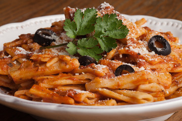 Close-up of plate of baked Rigatoni pasta with marinara sauce