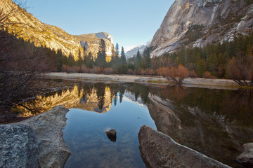 Peaceful and serene reflection of mountains and trees at mirror lake in Yosemite National Park