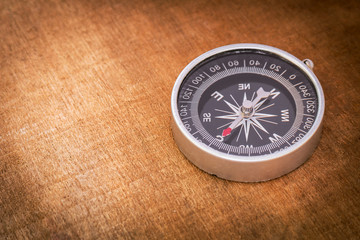 Fototapeta na wymiar Compass on wooden background