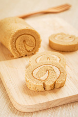 Coffee roll cake on wooden board