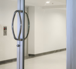 Glass door with chrome metal handle