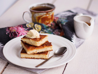 pieces casseroles on a round plate and a cream, coffee, honey