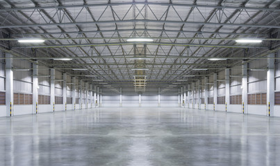Concrete floor inside industrial building. Use as large factory, warehouse, storehouse, hangar or...