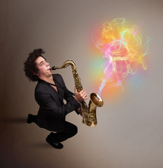 Attractive musician playing on saxophone with colorful abstract
