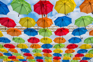 Fototapeta na wymiar Many umbrellas coloring the sky