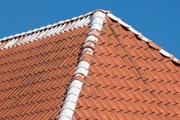 Red roof tiles with sky