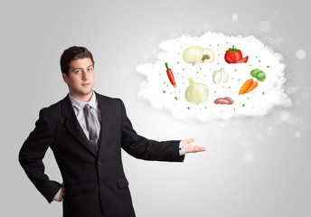 Handsome man presenting a cloud of healthy nutritional vegetable