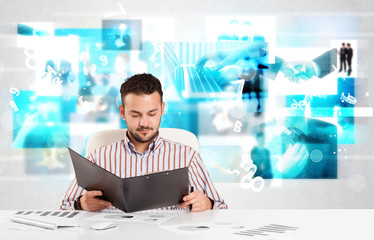 Business person at desk with modern tech images at background