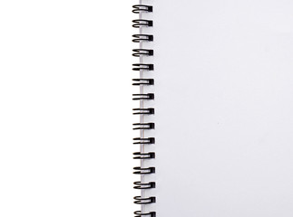 Close up of blank spiral notebook, isolated on white