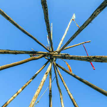 Tipee stakes and ribbons shown against a blue sky