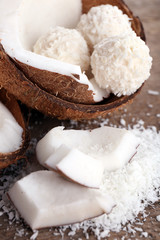 Broken coconut on wooden background