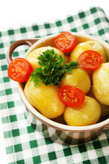 Young boiled potatoes in bowl, close up