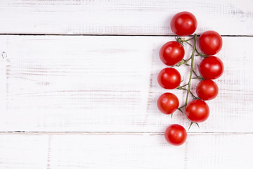 Naklejka na ściany i meble cherry tomatoes on white wooden background