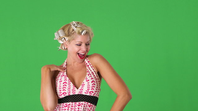 Young woman with rollers in her hair being funny and blowing kis