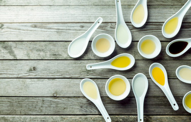 Topview of soup spoons and sauce dishes with oil